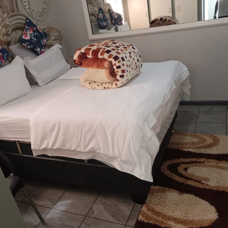 Guest room with queen bed at One Love Suites guest house in Mokopane