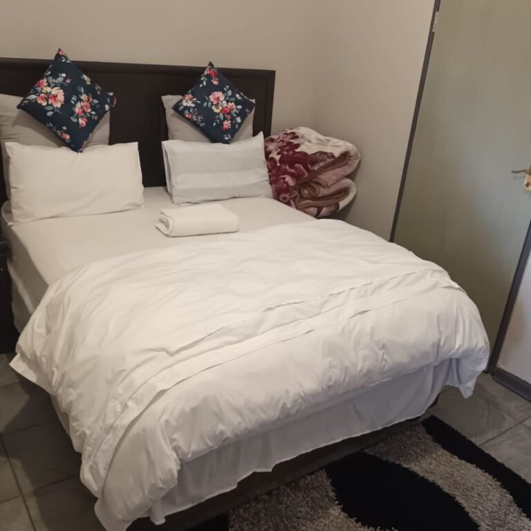 Queen bed room at One Love Suites guest house in Mokopane